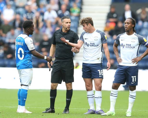 Preston North End's Ryan Ledson and Peterborough midfielder Siriki Dembele have words at Deepdale