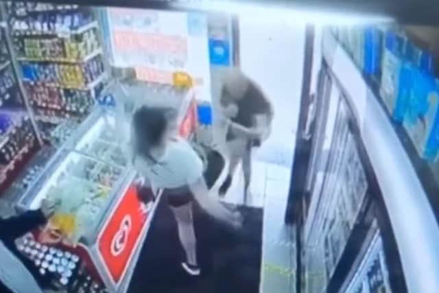 A still of the moment a young Preston mum kicked a man out of shop after an altercation.