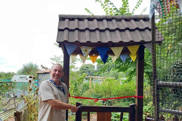Steven Smith allotment officer at Preston City Council cutting the ribbon and officially opening the wildlife garden