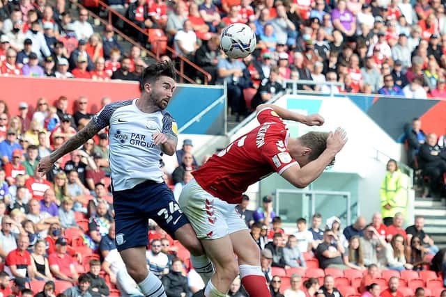 PNE striker Sean Maguire competes in the air with Bristol City defender Rob Atkinson