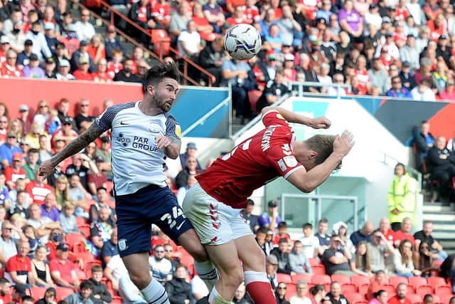 PNE striker Sean Maguire competes in the air with Bristol City defender Rob Atkinson