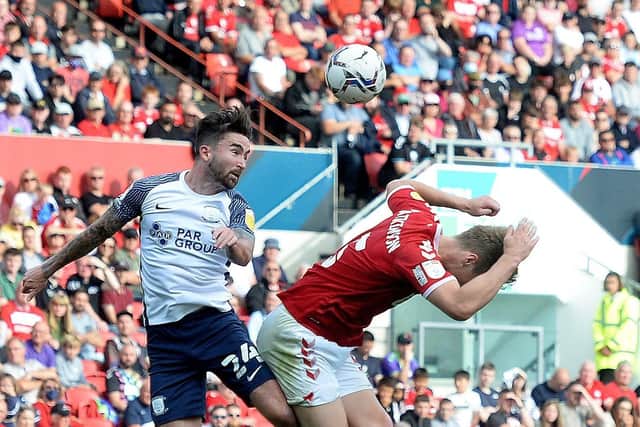 Sean Maguire battles with Rob Atkinson in the air