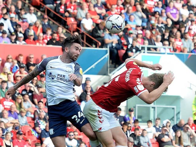 Sean Maguire battles with Rob Atkinson in the air