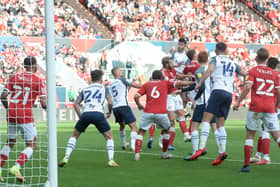 Andrew Hughes gets a header in on goal as PNE look for a way through