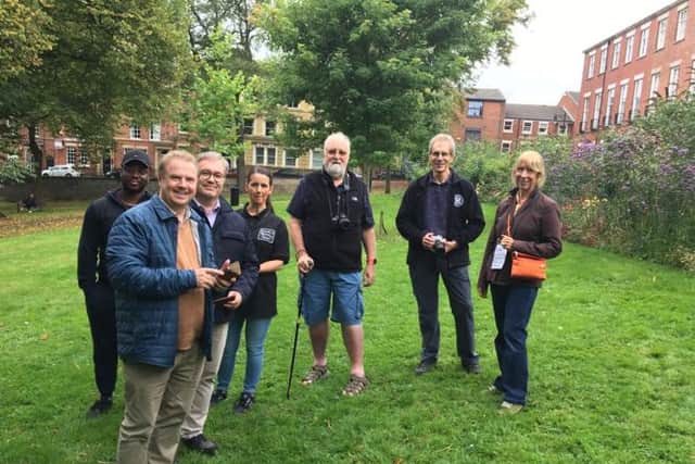 Photographer  Paul Rushton, (second from right), from Preston Photogpraphic Society leads a photography workshop in Winckley Square Gardens.