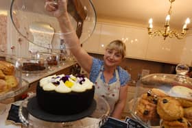 Sally showing off some of The Whittle Village Tea Room’s sweet treats