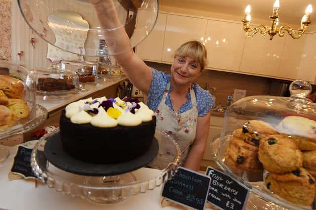 Sally showing off some of The Whittle Village Tea Room’s sweet treats