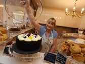 Sally showing off some of The Whittle Village Tea Room’s sweet treats