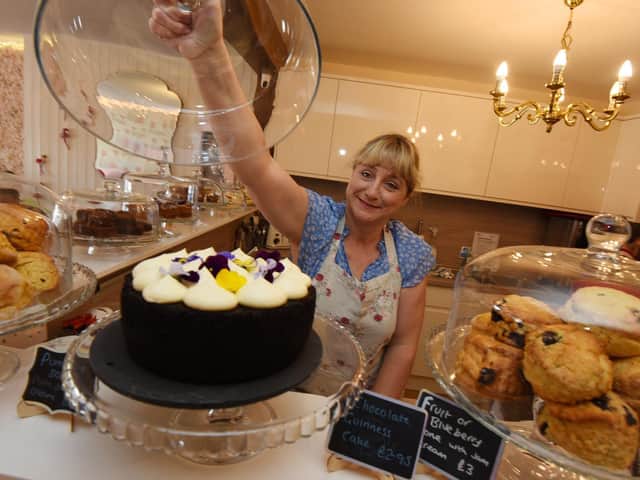 Sally showing off some of The Whittle Village Tea Room’s sweet treats