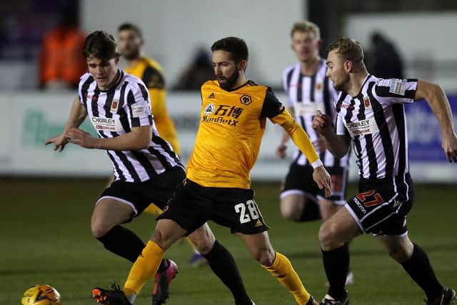 Chorley's MIke Calvley, left, and Connor Hall track Wolves João Moutinho during the FA Cup clash last season