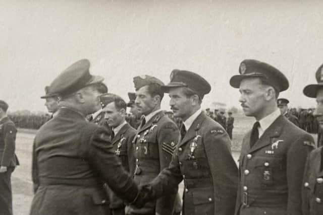 Jan Kozicki is awarded the Polish Cross of Valour. He is pictured shaking hands with a senior Polish officer in 1945
