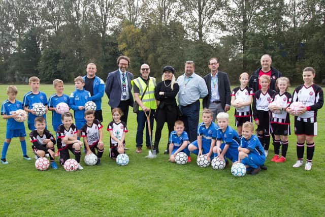 Liv Cooke with young footballers and other dignitaries at the Playing Pitch Hub