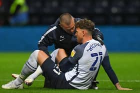 Preston North End striker Connor Wickham receives attention from physio Matt Jackson