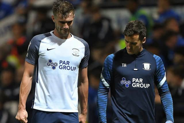 Liam Lindsay leaves the pitch with a knee injury in the first half of PNE's win against Cheltenham