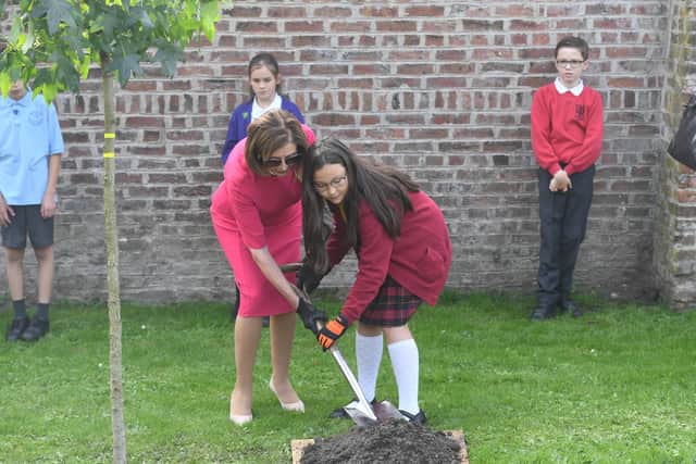 US House of Representatives Speaker Nancy Pelosi is helped to plant a tree by Chorley schoolgirl Amy Sasaki during the G7 Speakers' Summit at Astley Hall (image: UK Parliament/Jessica Taylor)