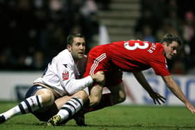 Preston North End striker Jon Parkin gets to grips with Liverpool's Jamie Carragher at Deepdale in January 2009