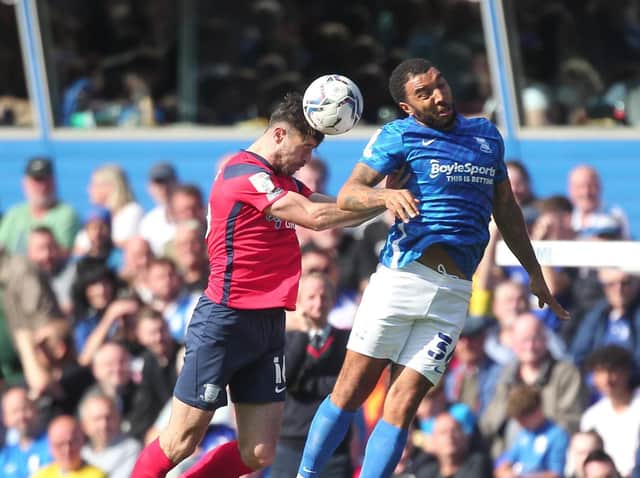 Preston North End defender Andrew Hughes challenges Birmingham striker Troy Deeney in the air at St Andrew's