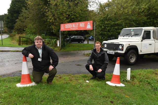County Cllr Mark Clifford and Cuerden Valley Park manager Iollan Banks on the patch of land where vehicles have previously become bogged down after parking - apparently to avoid having to pay in the facility's official car park just yards away (image: Neil Cross)
