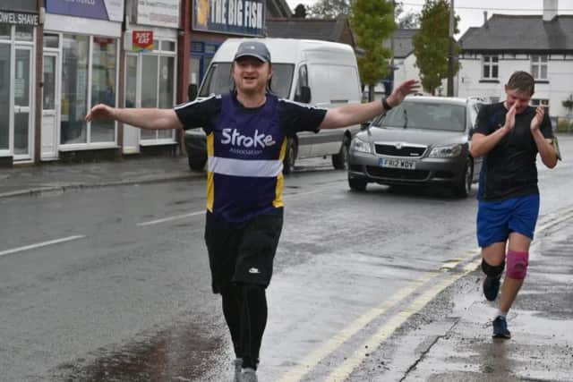 Michael crosses the finish line in Longton with his last lap running mate Ben Wolfenden after the gruelling two-day fundraiser.
