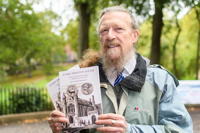 David shows off the cover of his book. All proceeds will go to St Catherine's Hospice.