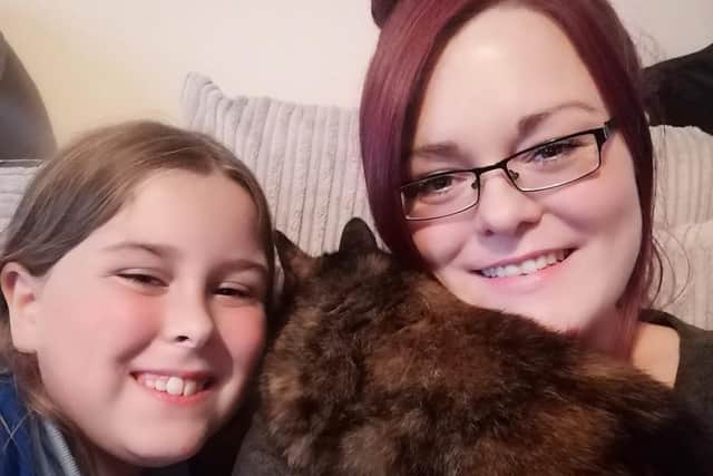 Katie Powell and daughter Ella, from Layton, Blackpool, are reunited with their missing cat Milly, which had been found in the rafters of the roof of a supermarket on Talbot Street, Blackpool