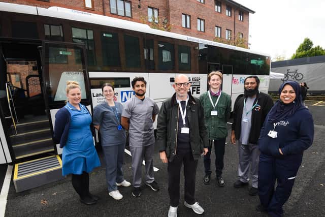 A covid vaccination bus came to the UCLan campus, staffed by The Greater Preston Network. In the middle is the network's clinical director, Jeremy Hann.