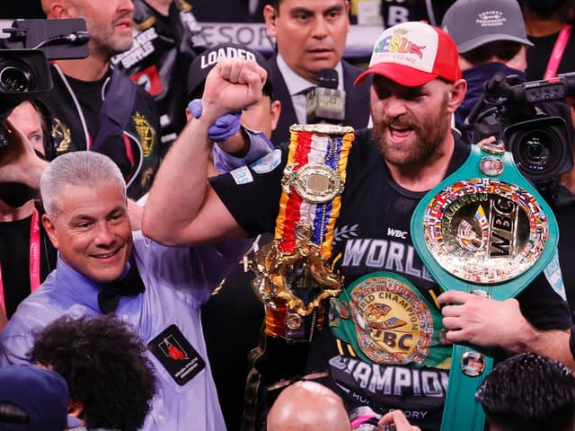 Referee Russell Mora holds up the arm of Tyson Fury as he celebrates his 11th-round knockout of Deontay Wilder to retain his WBC heavyweight title at T-Mobile Arena on October 9, 2021 in Las Vegas, Nevada.