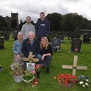 Brenda's husband Jack at the graveside with daughters Jane Harrison and Joanne Brooks and grandsons Jack and Alex.