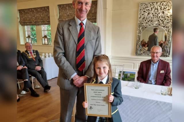 Ashbridge Independent School year 3 pupil, Penelope Brindle, collecting the award from Ralph Assheton, previous High Sheriff of Lancashire.