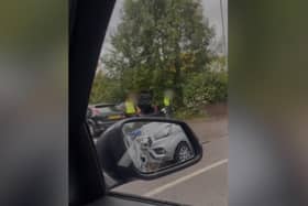 In the video, two men in hi-viz bids and safety helmets can be seen flinging rubbish from the boot of a black Ford car into a hedge in the B&M car park in Carlisle Street, Preston