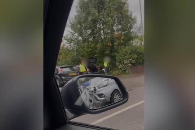 In the video, two men in hi-viz bids and safety helmets can be seen flinging rubbish from the boot of a black Ford car into a hedge in the B&M car park in Carlisle Street, Preston