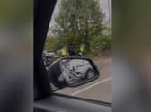 In the video, two men in hi-viz bids and safety helmets can be seen flinging rubbish from the boot of a black Ford car into a hedge in the B&M car park in Carlisle Street, Preston