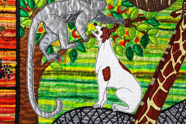 A dog tries to talk to a monkey, just one of the fun touches to be discovered among the 12 huge panels produced by Jacqui Parkinson for Threads Through Creation at Lancaster Priory until November 3.
