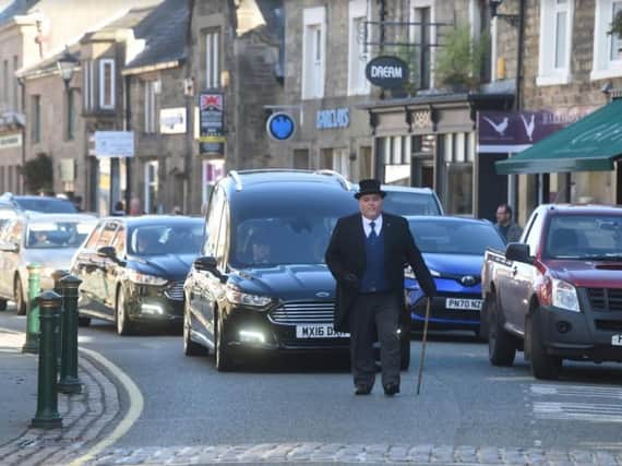 Bob's funeral cortege moves slowly along Garstang's High Street where he used to patrol.