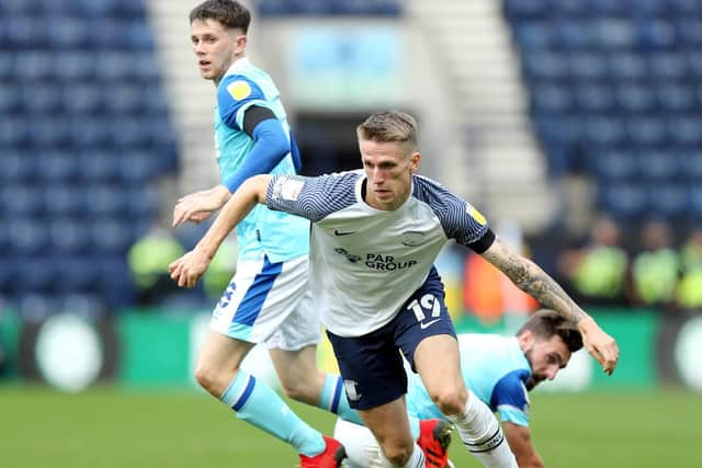 North End striker Emil Riis evades two Derby defenders at Deepdale