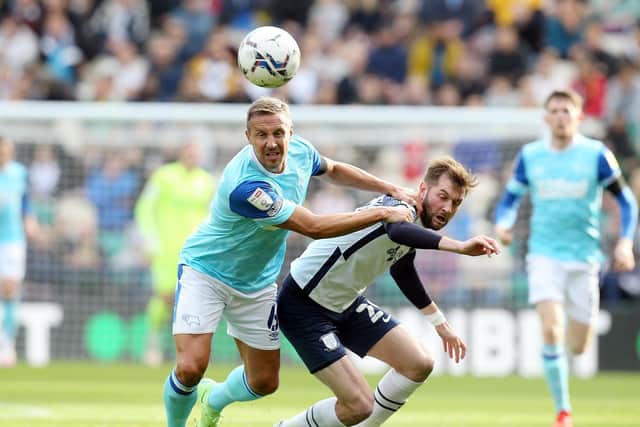 North End's Tom Barkhuizen challenges for the ball against Derby