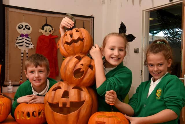 Oscar Lee, Emilia Pawlak and Evie Patton from Lea Community Primary School carving some of the pumpkins last Friday.