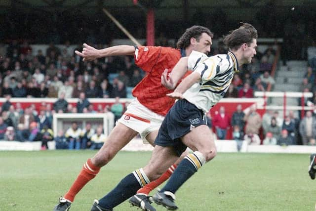 PNE striker Tony Ellis gets ahead of Blackpool defender Gary Briggs at Bloomfield Road