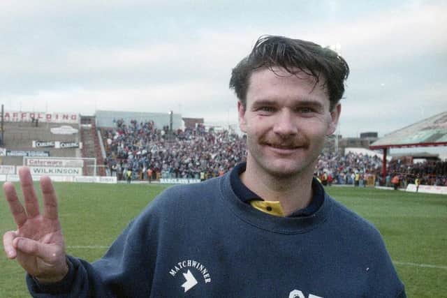 A dazed but happy Tony Ellis celebrates his hat-trick against Blackpool, with the PNE fans in the background