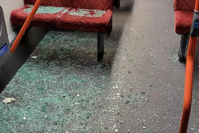 The driver said he saw three boys hurl something at the bus moments before two of its windows exploded, spraying shattered glass over his passengers