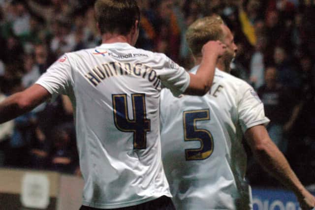 Paul Huntington and Tom Clarke celebrate Preston North End 's winning goal against Blackpool at Deepdale in August 2013