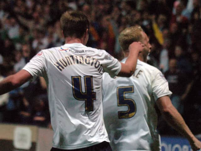 Paul Huntington and Tom Clarke celebrate Preston North End 's winning goal against Blackpool at Deepdale in August 2013