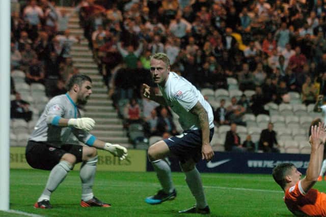 Tom Clarke wheels away after scoring against Blackpool in 2013