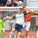 Preston North End striker Emil Riis challenges in the air with Blackpool's Richard Keogh