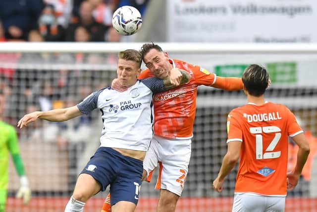 Preston North End striker Emil Riis challenges in the air with Blackpool's Richard Keogh