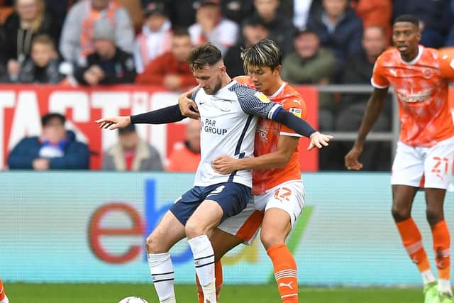 PNE skipper Alan Browne holds off Blackpool's Kenny Dougall