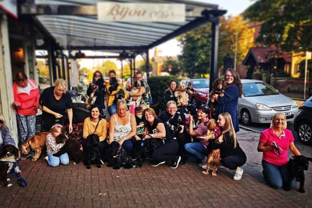 Dog owners and their pets get together for a photo after an event at Bijou of Lytham before the pandemic