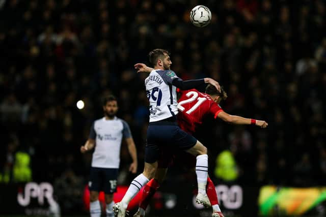 PNE's Tom Barkhuizen challenges in the air with Kostas Tsimikas