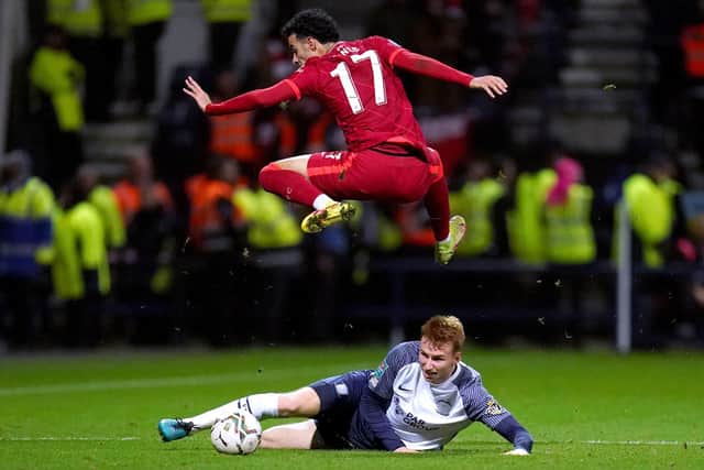 Liverpool's Curtis Jones jumps high to avoid Sepp van den Berg