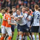 Preston North End and Blackpool players have an exchanged of views in the derby clash at Bloomfield Road